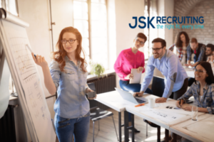 A group of people in an office setting.