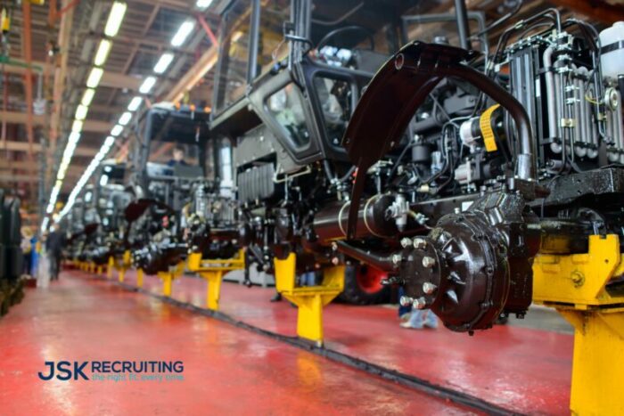 A line of trucks in a shop with the word recruiting on it.