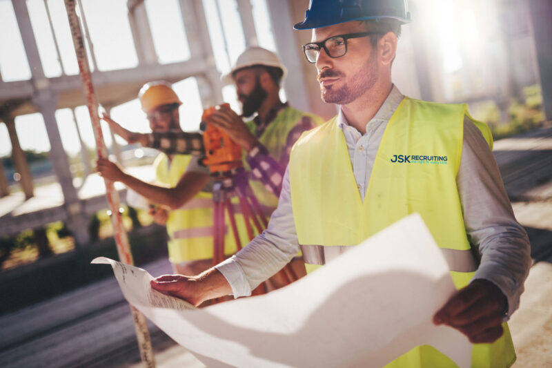 A group of men in yellow vests and hard hats.